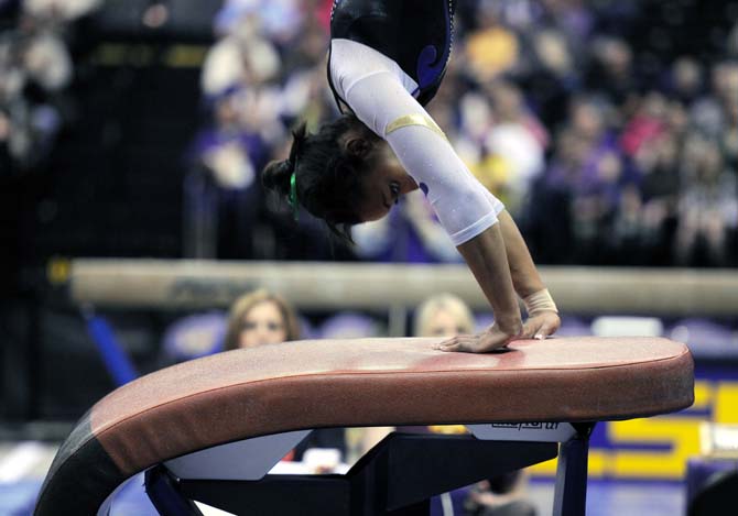 LSU junior all-around Maliah Mathis springs off the vualt Jan. 4, 2013 during the Tiger's 196-194 win over NC State in the PMAC.
 