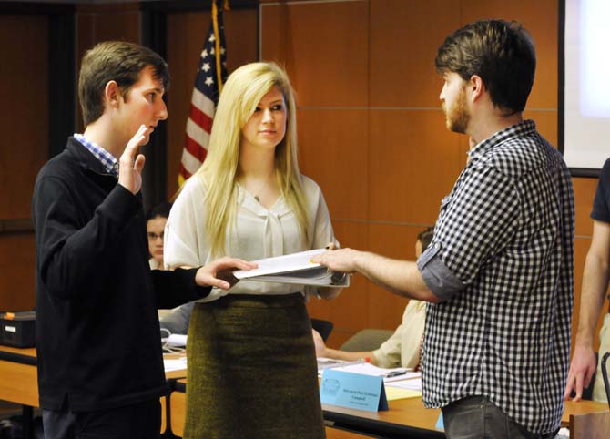 Speaker of the Senate Meredith Westbrook swears in Zachary Fitzpatrick (left) for the College of Science and Austin Matthews for the College of Mass Communication (right) at the weekly Student Government Senate meeting on Jan. 30, 2013.
 