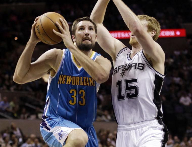 New Orleans Hornets' Ryan Anderson (33) drives past San Antonio Spurs' Matt Bonner (15) during the first quarter of an NBA basketball game, Wednesday, Jan. 23, 2013, in San Antonio. (AP Photo/Eric Gay)
 