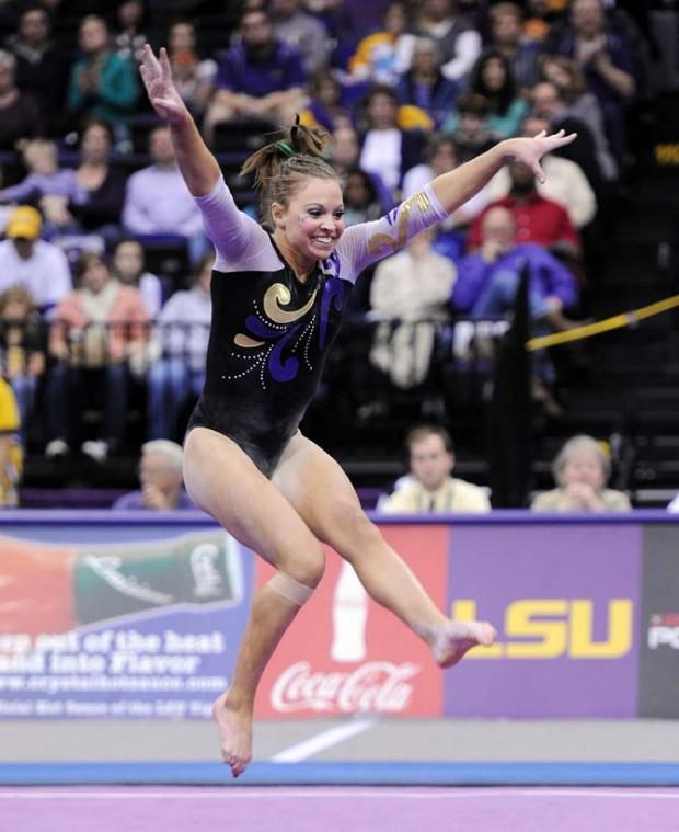 LSU junior all-around Kaleigh Dickson smiles and jumps through the air Jan. 4, 2013 during the Tiger's 196-194 win over NC State in the PMAC.
 