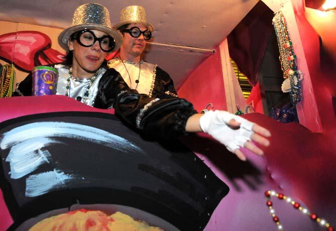 Members of the Krewe of Jupiter and Juno throw beads from their float Saturday Jan. 26, 2013 in front of the Baton Rouge River Center.
 