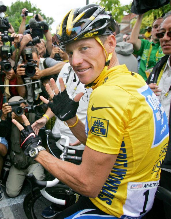 FILE - In this July 24, 2005 file photo showing overall leader Lance Armstrong, of Austin, Texas, surrounded by press photographers, signaling seven, for his seventh straight win in the Tour de France cycling race, prior to the start of the 21st and final stage of the race, between Corbeil-Essonnes, south of Paris, and the French capital. After more than a decade of denying that he doped to win the Tour de France seven times, Armstrong was set to sit down Monday, Jan. 14, 2013, in Austin, Texas, for what has been trumpeted as a "no-holds barred," 90-minute, question-and-answer session with Oprah Winfrey. (AP Photo/Peter Dejong, File)
 