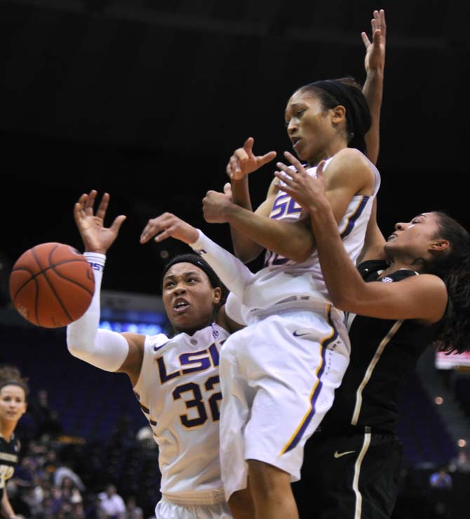 LSU freshman guard Danielle Ballard (32) and LSU senior guard Adrienne Webb (10) reach for the ball Sunday, Jan. 20, 2013 during the 54-51 victory over the Vanderbilt Commodores in the PMAC.
 