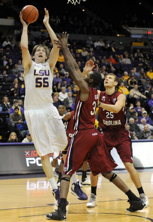 LSU senior center Andrew Del Piero (55) shoots Wednesday, Jan. 16, 2013 over University of South Carolina's junior forward RJ Slawson (33) and freshman forward Mindaugas Kicinas (25) during the Tigers' 73-82 overtime loss to the Gamecocks in the PMAC.
 