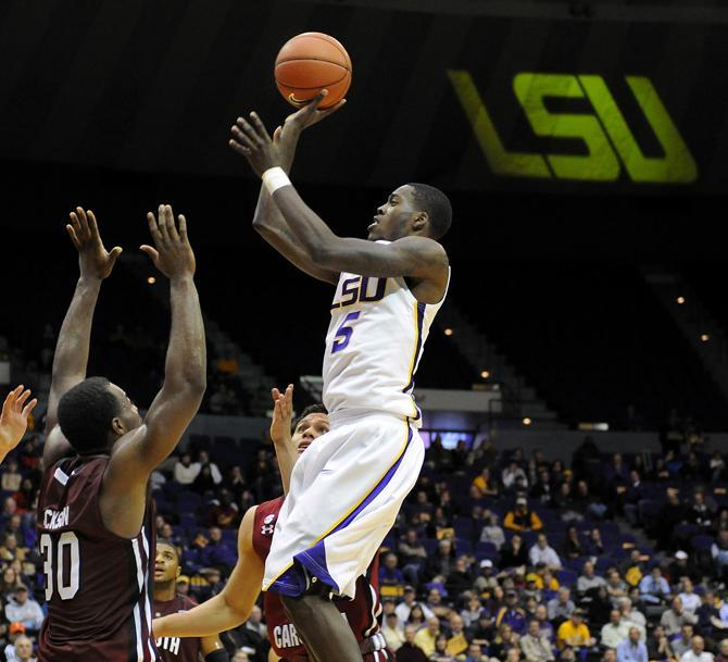 LSU junior forward Shavon Coleman (5) jumps Wednesday, Jan. 16, 2012 over University of South Carolina's senior guard Lakeem Jackson (30) in the Tigers' 73-82 loss to the Gamecocks in the PMAC.
 