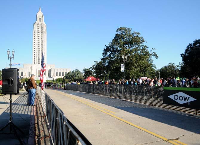 Spectators wait and watch family members and friends as they run into the final stretch of the half-marathon in front of the State Capitol on Jan. 20, 2013.
 