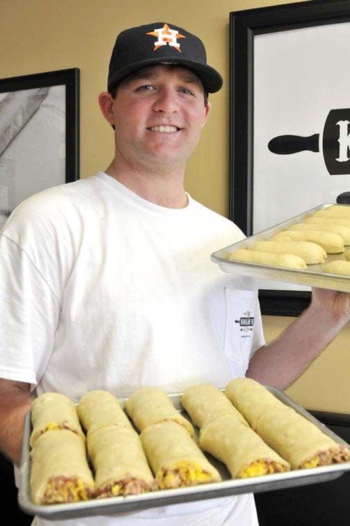 Kolache Kitchen owner Will Edwards poses with trays of prepared kolaches Saturday January 12, 2013 inside his restaurant on Nicholson Drive.
 