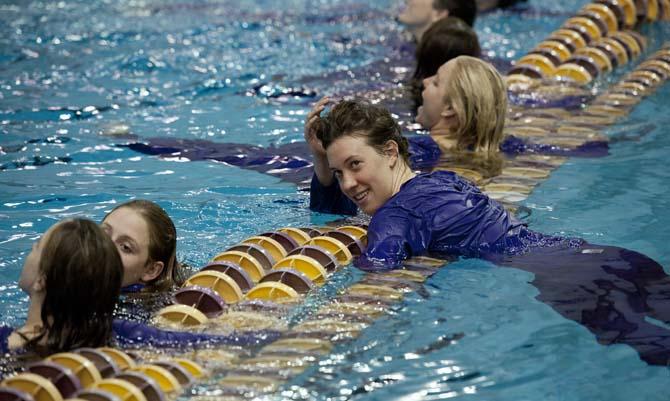 LSU senior Kaelee Mader looks at some of her fellow team mates outside of the pool right after the girls swim meet against Houston, Rice, and Tulane in the Natatorium on Jan. 26, 2013. As a part of the senior day, all of the senior swimmers jumped into the diving well from the high dive.
 