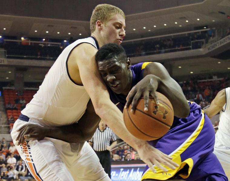 LSU forward Johnny O'Bryant III (2) is fouled as he drives to the basket by Auburn center Rob Chubb (41) in the first half of an NCAA college basketball game at Auburn Arena in Auburn, Ala., Wednesday, Jan. 9, 2013. (AP Photo/Dave Martin)
 