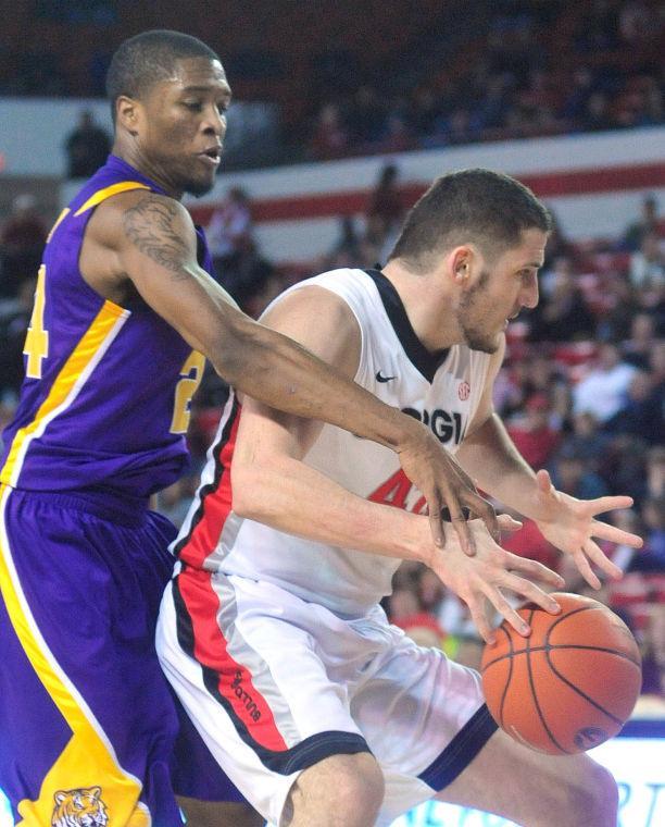 LSU guard Malik Morgan (24) knocks the ball loose from Georgia forward Nemanja Djurisic (42) during the first half of an NCAA college basketball game Saturday, Jan. 19, 2013, in Athens, Ga. (AP Photo/Athens Banner-Herald, Richard Hamm) MANDATORY CREDIT MAGS OUT
 