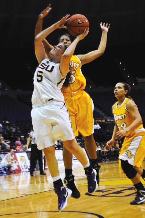 LSU junior guard Jeanne Kenney (5) jumps past Xavier defenders Thursday, Nov. 1, 2012, during the Tigers' 75-34 victory against the Gold Nuggets at the PMAC.