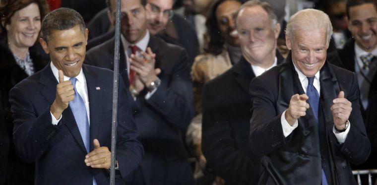 President Barack Obama and Vice President Joe Biden react during the inaugural parade on Pennsylvania Avenue near the White House, Monday, Jan. 21, 2013, in Washington. Thousands marched during the 57th Presidential Inauguration parade after the ceremonial swearing-in of President Barack Obama. (AP Photo/Gerald Herbert)
 