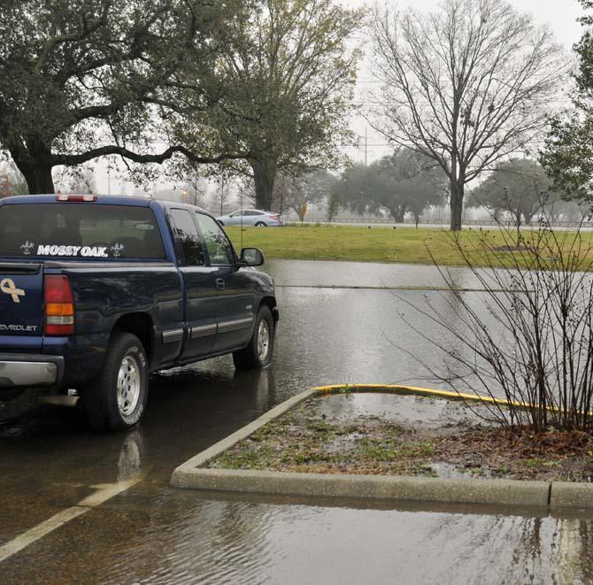 A student's truck is parked in standing water Jan. 9, 2013 in a commuter lot off of Nicholson Drive after heavy rains flooded areas around campus.
 