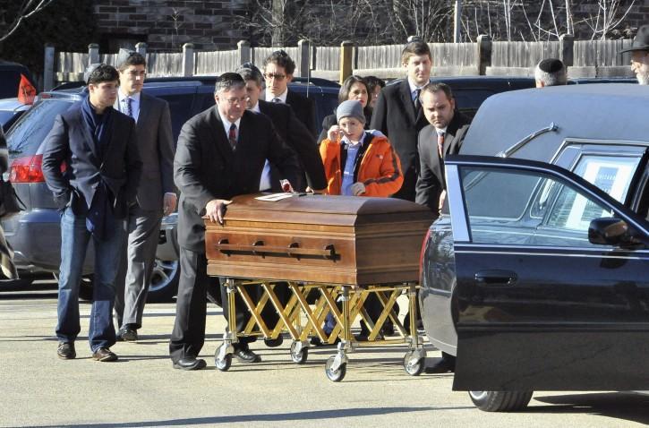 The casket of Internet activist Aaron Swartz is wheeled Thursday to a hearse outside Highland Park&#8217;s Lubavitch Chabad Central Avenue Synagogue. Swartz, 26, was found dead Jan. 11 of an apparent suicide Friday in his New York apartment.
 