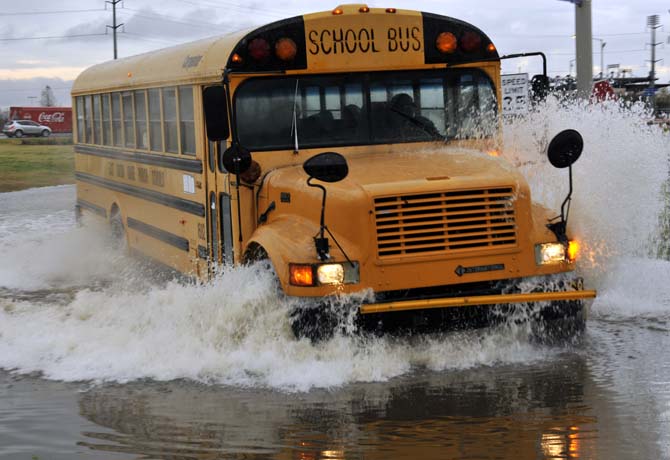 A bus drives Thursday, Jan. 10, 2013 through the flooded road near the corner of Burbank Drive and Nicholson Drive.
 