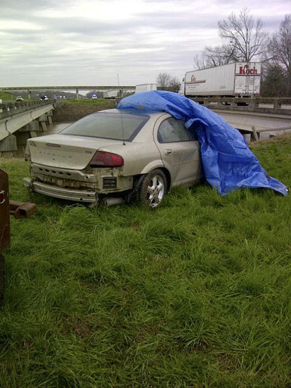 In this Wednesday, Jan 30, 2013 photo released by the Louisiana State Police, a vehicle sits in the median after being pulled out of the Tensas River west of Tallulah, La. Police spokeswoman Julie Lewis says 49-year-old Brady Brown and 52-year-old Ella Williams, both of Beaumont, Texas, and Brown's 68-year-old uncle, Eddie Cobb Jr., apparently drowned after their 2006 Dodge Stratus ran off the road after a funeral in Columbia, S.C. (AP Photo/Louisiana State Police)
 