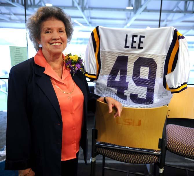 Assistant registrar Patricia Lee beams next to her new personalized LSU jersey during a retirement party Thursday Feb. 21, 2013 in Tiger Stadium. Lee and her co-worker Patricia Yancey are retiring at the end of this semester.
 