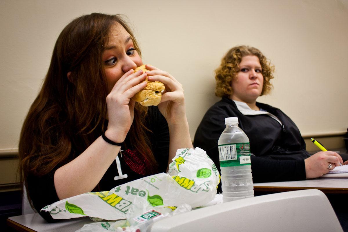 Jessica St. John eats her tuna Subway sandwich in class while distracting Jessica Sprick.