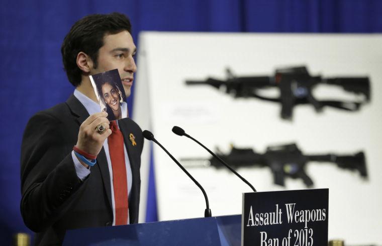 Omar Samaha, holds a picture of his sister Reema Samaha, who was killed in the Virginia Tech. shootings, Thursday, Jan. 24, 2013, during a news conference on Capitol Hill in Washington to introduce legislation on assault weapons and high-capacity ammunition feeding devices. Congressional Democrats are reintroducing legislation to ban assault weapons but the measure faces long odds even after last month's mass school shooting in Newtown, Conn. The measure being unveiled Thursday is authored by Democratic Sen. Dianne Feinstein of California, who wrote the original assault weapons ban. That law expired in 2004 when Congress refused to renew it under pressure from the National Rifle Association. (AP Photo/Manuel Balce Ceneta)
 