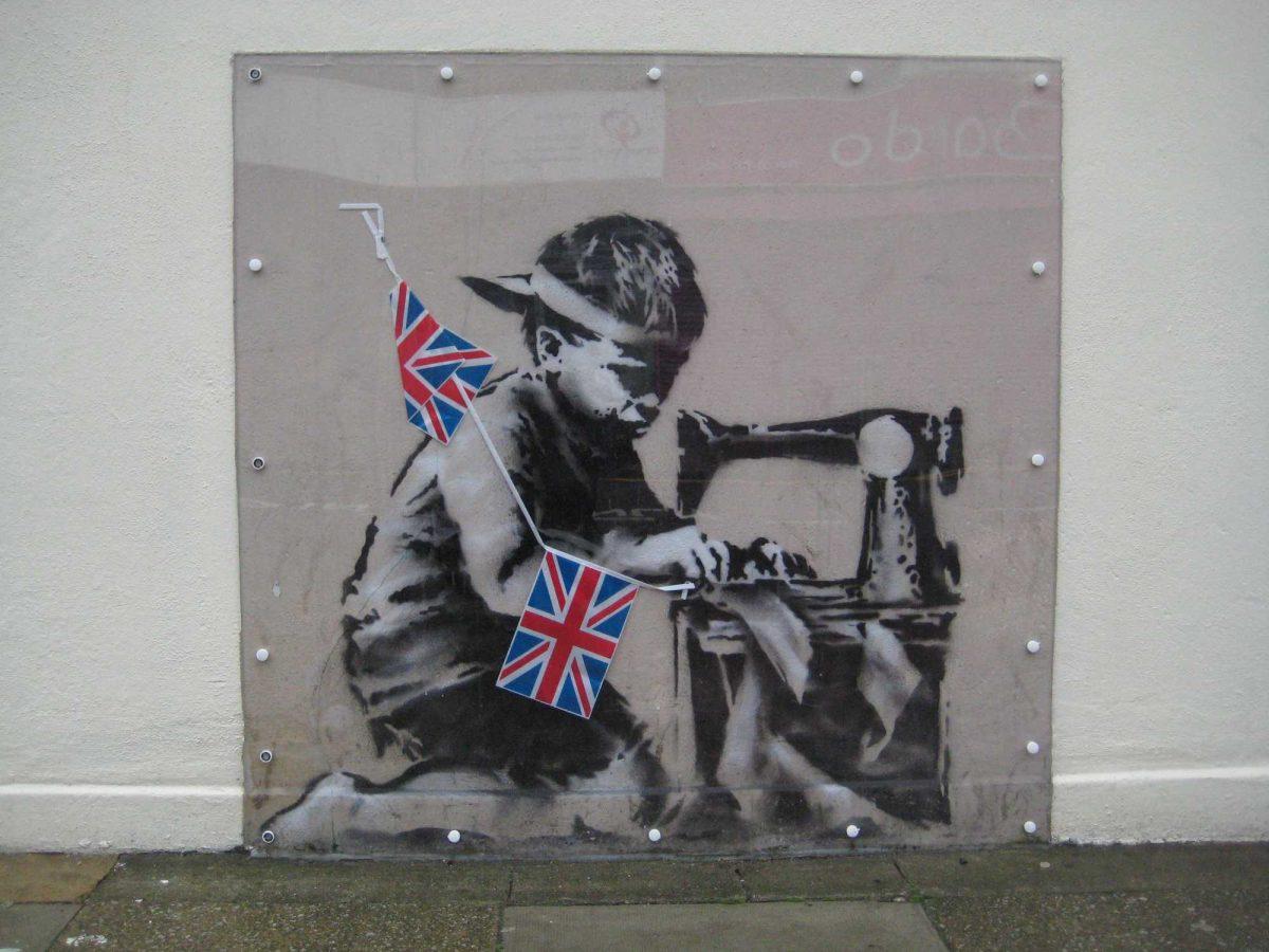 This is an undated image of an art work from British artist Banksy made available by Haringey Council Wednesday Feb. 20, 2013. The stencil by the famed, secretive graffiti artist of a young boy sewing Union Jack bunting on an antique sewing machine appeared on the side of a north London bargain store last May. Soon the gritty Turnpike Lane area was drawing art lovers keen to see Banksy's typically cheeky take on the Diamond Jubilee celebrations of Queen Elizabeth II's 60 years on the British throne. Last week it vanished, leaving nothing but a rectangle of exposed brick &#8212; only to reappear on the website of a Miami auction house. Listed as "Slave Labor (Bunting Boy)," it is due to be sold Saturday with an estimated price of between $500,000 and $700,000. (AP Photo/Haringey Council) NO ARCHIVE