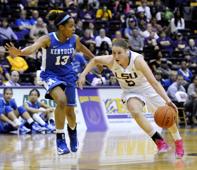 LSU junior guard Jeanne Kenney (5) moves the ball past Kentucky sophomore guard Bria Goss (13) on Sunday, Feb. 24, 2013 during the Tigers' 77-72 victory against the Wildcats.
 