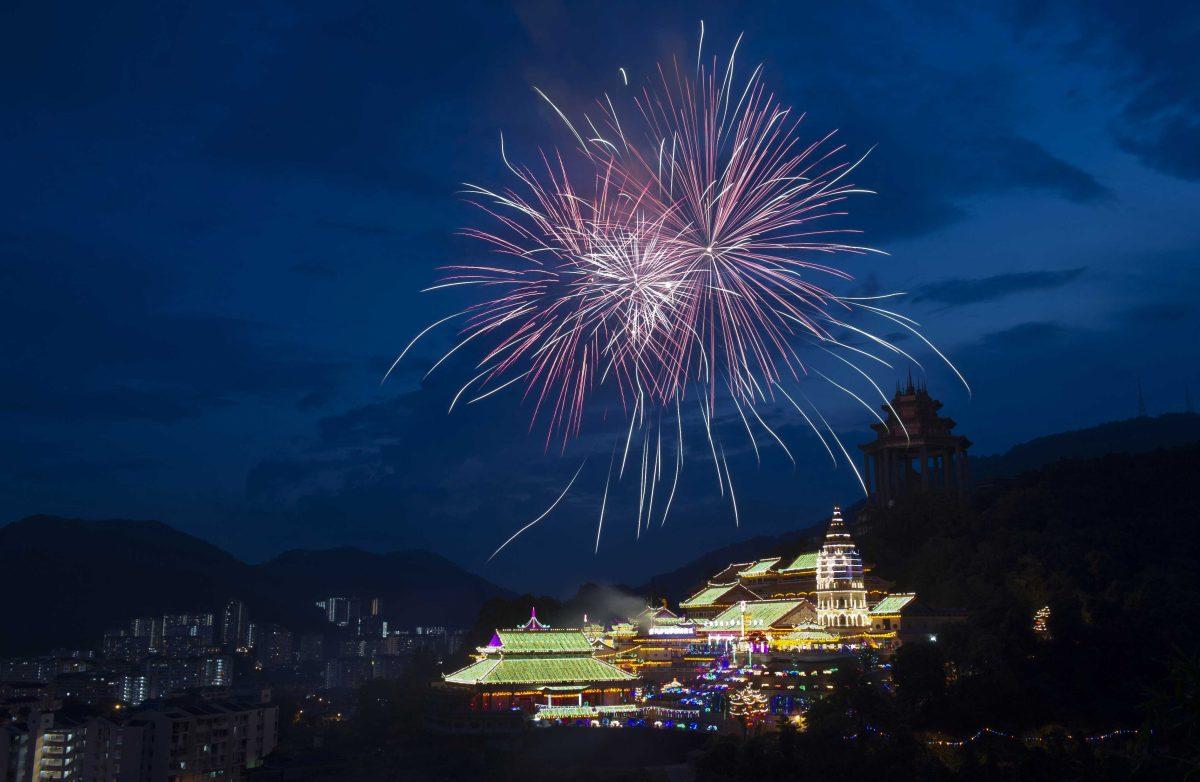 In this photo taken Wednesday, Feb. 6, 2013, fireworks explode over Kek Lok Si Buddhist temple with lighting decorations as part of the upcoming Chinese New Year celebrations in Penang Island, northwestern Malaysia. Chinese Lunar New Year falls on Feb. 10. (AP Photo/Gary Chuah)