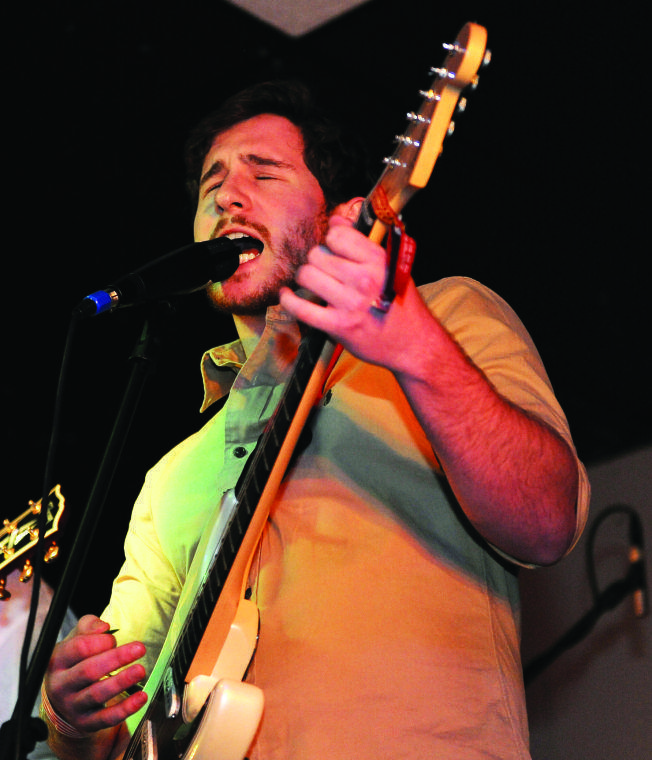 Economics sophomore and Stone Rabbits lead vocalist and guitarist Ben Burbrink sings into the microphone Saturday, Feb. 2, 2013 during a show at Shady's.
 