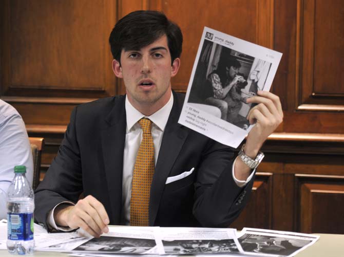 Finance junior and Student Government presidential candidate John Woodard holds a piece of evidence presented by his opponent Thursday, Feb. 14, 2013, during a UCourt hearing in the LSU Student Union.
 