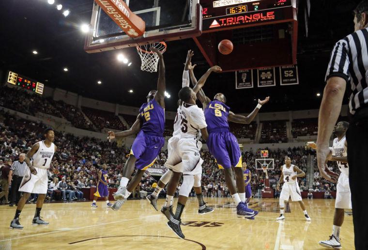 LSU forwards Johnny O'Bryant III (2) and Shavon Coleman (5) compete against Mississippi State defenders, including forward Roquez Johnson (25), for a rebound in the second half of an NCAA college basketball game in Starkville, Miss., Saturday, Feb. 2, 2013. LSU won 69-68. (AP Photo/Rogelio V. Solis)
 