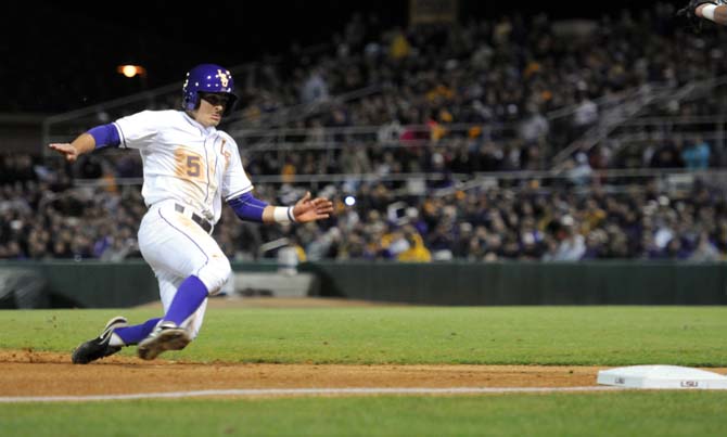 LSU sophomore outfielder Chris Sciambra (5) prepares to slide into third base Friday Feb. 15, 2013 during the Tigers' 1-0 shutout against Maryland in Alex Box Stadium.
 