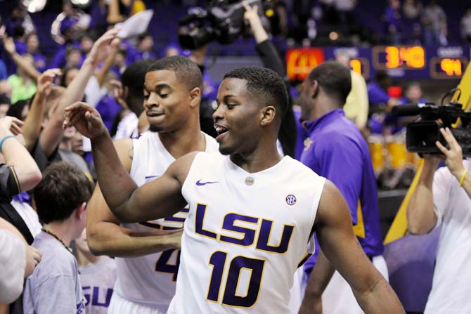 LSU junior guard Andre Stringer (10) celebrates with fans and teammates Saturday, Feb. 23, 2013 after the Tigers' 97-94 triple overtime victory against the Crimson Tide. Stringer scored 10 out of the Tigers' 97 points.
 