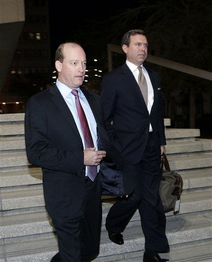 Lamar McKay, former president of BP America and current chief executive of BP's Upstream unit, left, leaves Federal Court after testifying in New Orleans, Tuesday, Feb. 26, 2013. McKay, who was president of BP America at the time of the Deepwater Horizon disaster, became the first BP executive to testify at the federal trial intended to identify the causes of BP's Macondo well blowout and assign percentages of blame to the companies involved. (AP Photo/Gerald Herbert)
 