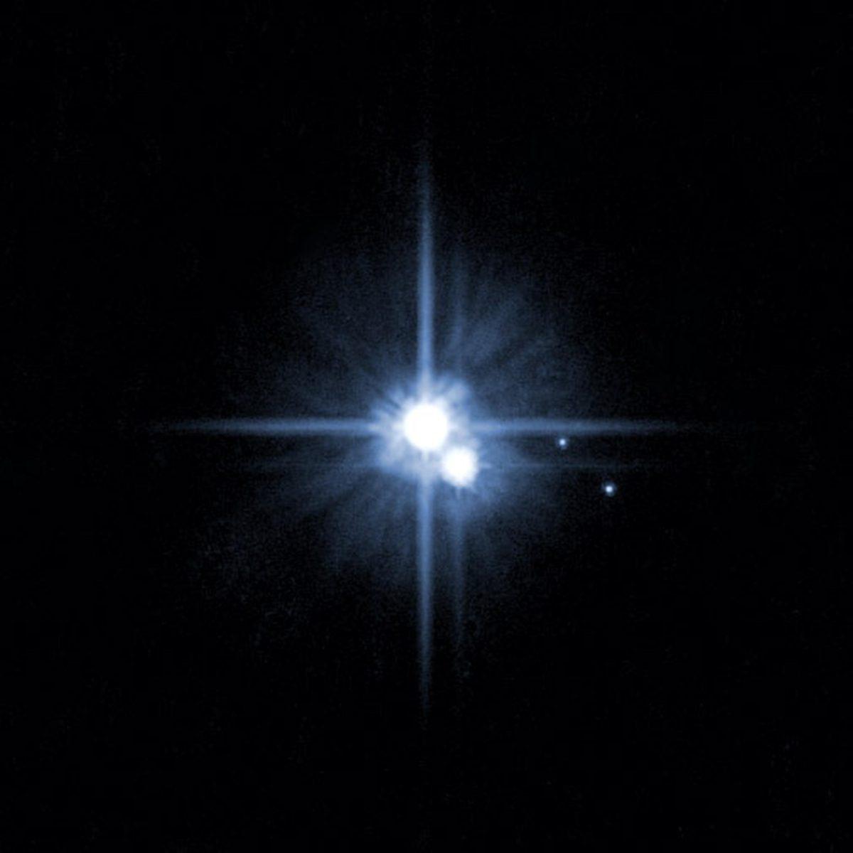 FILE - This file image provided by NASA on Feb. 22, 2006 from it's Hubble Space Telescope shows Pluto and three of it's five moons. An online vote to name Pluto's two newest, itty-bitty moon concluded Monday, Feb. 25, 2013, and the winner is Vulcan, a name suggested by actor William Shatner, who played Capt. Kirk in the original "Star Trek" TV series. (AP Photo/NASA, File)