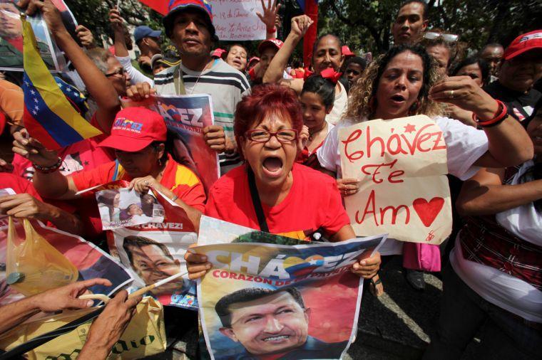 Supporters of Venezuela's President Hugo Chavez celebrate his return at Bolivar Square in Caracas, Venezuela, Monday, Feb. 18, 2013. Chavez returned to Venezuela early Monday after more than two months of treatment in Cuba following cancer surgery, his government said, triggering street celebrations by supporters who welcomed him home while he remained out of sight at the Carlos Arvelo Military Hospital in Caracas, where he will continue his treatment. (AP Photo/Fernando Llano)
 