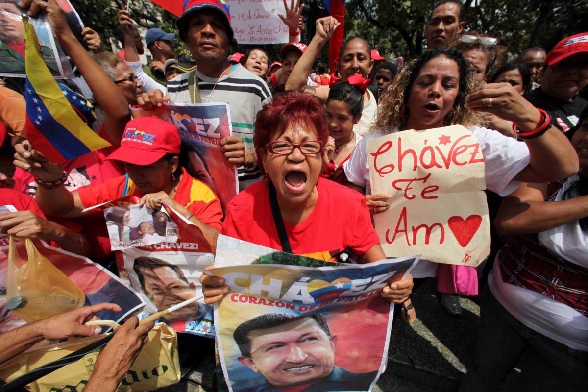 Supporters of Venezuela's President Hugo Chavez celebrate his return at Bolivar Square in Caracas, Venezuela, Monday, Feb. 18, 2013. Chavez returned to Venezuela early Monday after more than two months of treatment in Cuba following cancer surgery, his government said, triggering street celebrations by supporters who welcomed him home while he remained out of sight at the Carlos Arvelo Military Hospital in Caracas, where he will continue his treatment. (AP Photo/Fernando Llano)