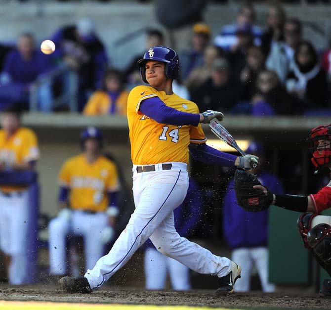 LSU junior infielder Christian Ibarra (14) has a face of concetration right after hitting the ball on Feb. 17, 2013 during the third game of the season against Maryland at Alex Box Stadium.
 