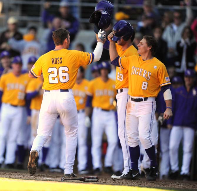 LSU junior catcher Ty Ross (26) gets congratulated by teammates JaCoby Jones (23) and Mason Katz (8) on Sunday, Feb. 17, 2013 during the 14-3 victory game against Maryland at Alex Box Stadium.
 