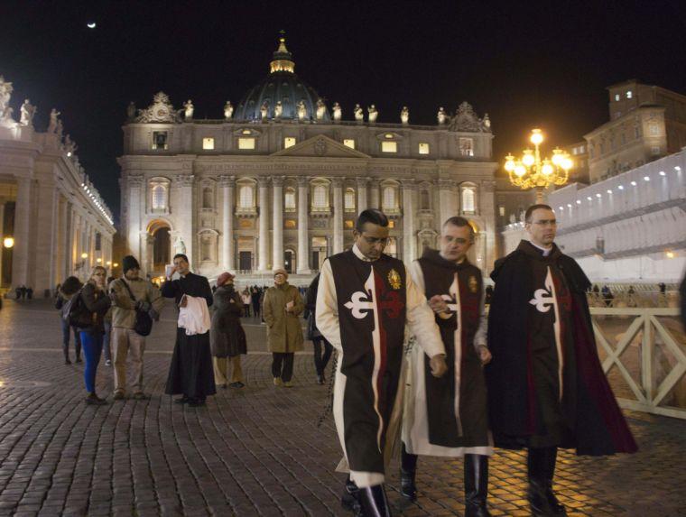 Participants leave after attending the Ash Wednesday mass celebrated by Pope Benedict XVI in St. Peter's Basilica, Wednesday, Feb. 13, 2013. With a few words in Latin, Pope Benedict XVI did what no pope has done in more than half a millennium, stunning the world by announcing his resignation Monday and leaving the already troubled Catholic Church to replace the leader of its 1 billion followers by Easter. (AP Photo/Domenico Stinellis)
 