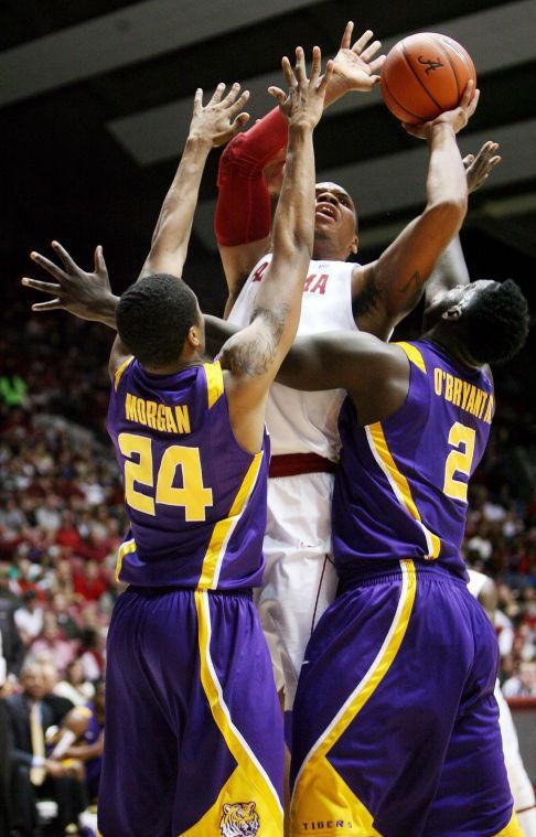 Alabama forward Nick Jacobs (15) tries to shoot between LSU guard Malik Morgan (24) and forward Johnny O'Bryant III (2) during the first half of their NCAA college basketball game, Saturday, Feb. 9, 2013, in Tuscaloosa, Ala. (AP Photo/The Tuscaloosa News, Michelle Lepianka Carter)
 