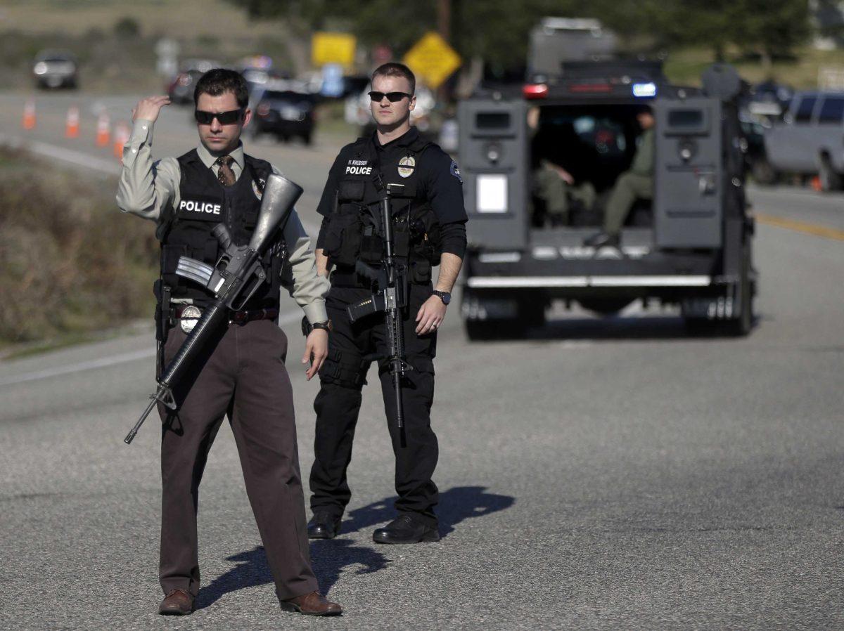 Law Enforcement personnel block Hwy 38 during the hunt for accused killer and ex-Los Angeles police officer Christopher Dorner in Yacaipa, Caif., Tuesday, Feb. 12, 2013. Dorner is believed to be barricaded in a cabin Tuesday after a furious gunbattle with police in the snow-covered mountains of Southern California, authorities said, the culmination of an intensive manhunt that left a region an edge for nearly a week. (AP Photo/Chris Carlson)