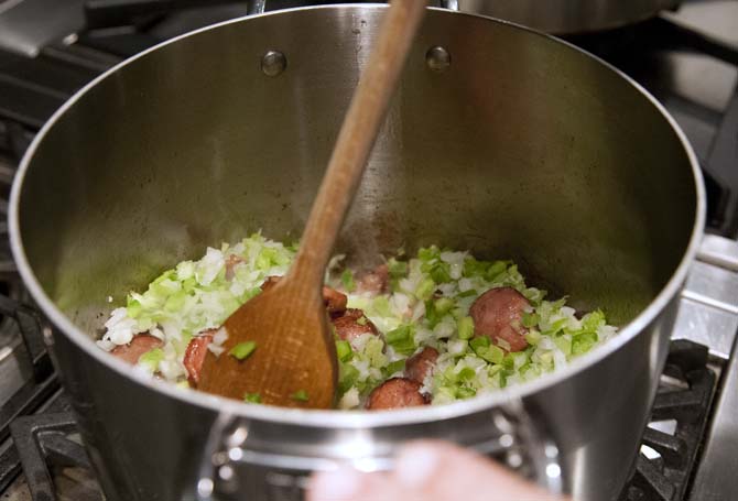 Some onions and other veggies get stirred into the pot of cooking sausage as a preliminary step to making gumbo at the gumbo Viking Cooking class at the Hilton Hotel on Jan. 31, 2013.
 