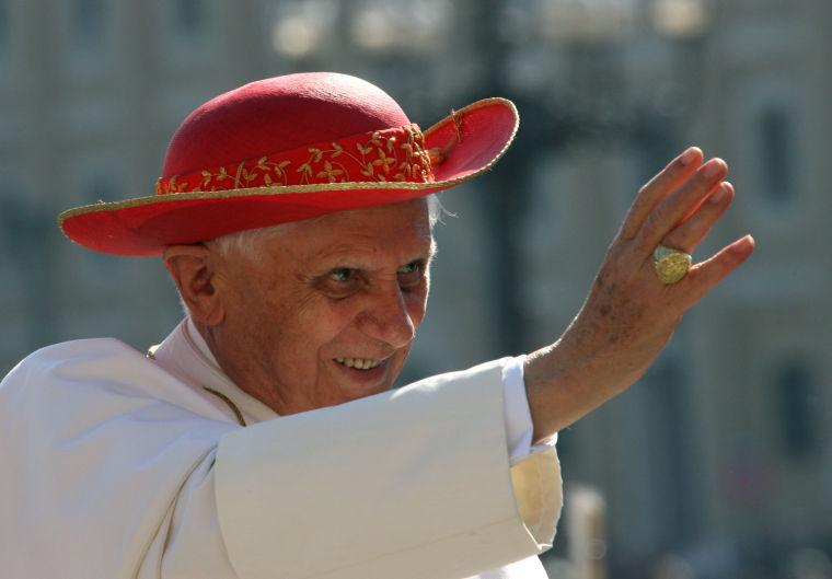 FILE - This Sept. 6, 2006 file photo shows Pope Benedict XVI wearing a "saturno hat", inspired by the ringed planet Saturn, to shield himself from the sun as he waves to the crowd of faithful prior to his weekly general audience in St. Peter's Square at the Vatican. (AP Photo/Pier Paolo Cito, files)
 