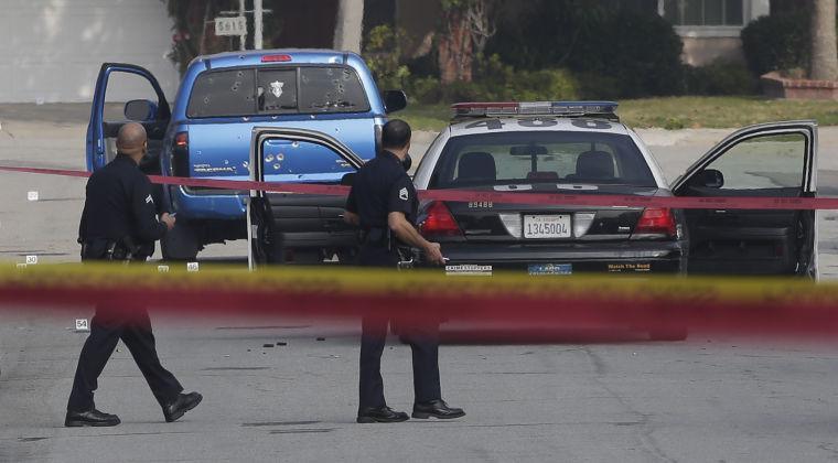 Law enforcement officers look over the scene of an officer involved shooting in Torrance, Calif., Thursday, Feb. 7, 2013. The shooting is believed to related to the manhunt for fired Los Angeles police officer, Christopher Dorner. (AP Photo/Chris Carlson)
 