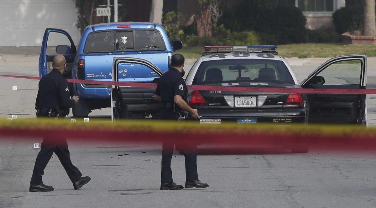 Law enforcement officers look over the scene of an officer involved shooting in Torrance, Calif., Thursday, Feb. 7, 2013. The shooting is believed to related to the manhunt for fired Los Angeles police officer, Christopher Dorner. (AP Photo/Chris Carlson)