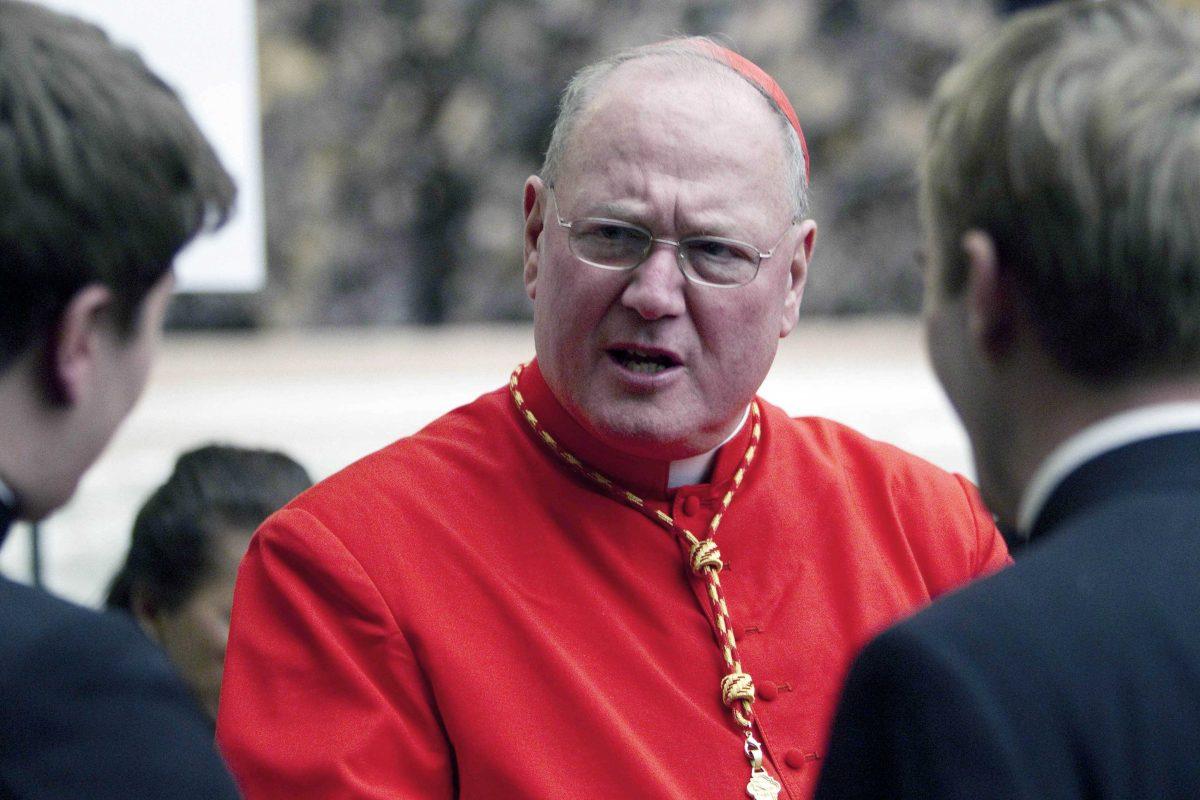 In this Saturday, Feb. 18, 2012 file photo, Cardinal Timothy Dolan, archbishop of New York, is congratulated by two unidentified prelates after being elevated in St. Peter's Basilica at the Vatican. According to a spokesman from the Archdiocese of New York City, Dolan has been deposed in New York on Wednesday, Feb. 20, 1023 in connection to accusations of sexual abuse in the Archdiocese of Milwaukee. (AP Photo/Andrew Medichini, File)