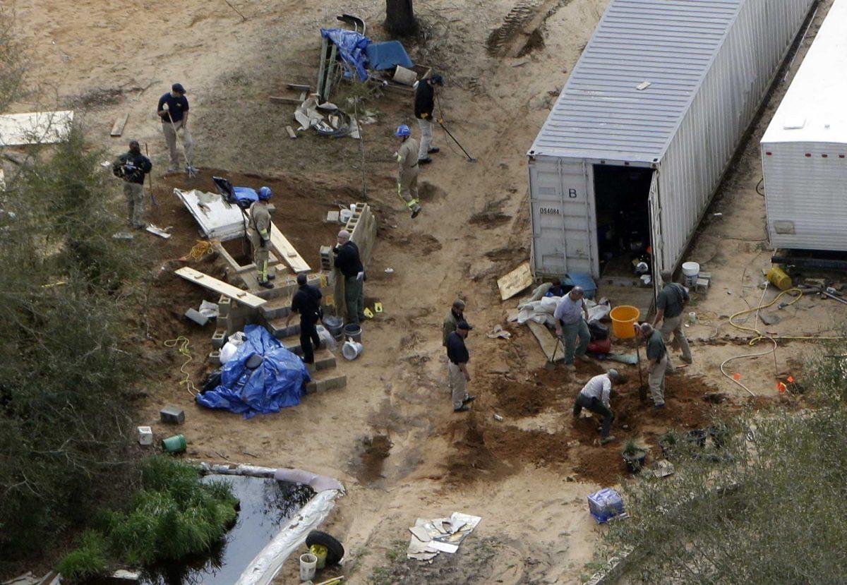 Authorities continue their investigation at the site in Midland City, Ala., on Friday, Feb. 8, 2013 where a five year old boy was held hostage in an underground bunker before being rescued Monday. Authorities shot and killed Jimmy Dykes after a week long standoff. The boy who was freed from an underground bunker is acting like a typical 5-year-old by all accounts, playing with toys and running around, but psychology experts and a woman who suffered through a similar ordeal warn there could be long-term emotional scars. (AP Photo/Dave Martin)