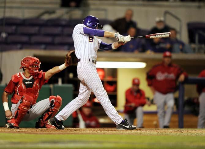 LSU freshman Mark Laird (9) takes a swing at the ball on Tuesday, Feb. 19, 2013 during the Tigers' 8-1 victory against the Lamar Cardinals.
 