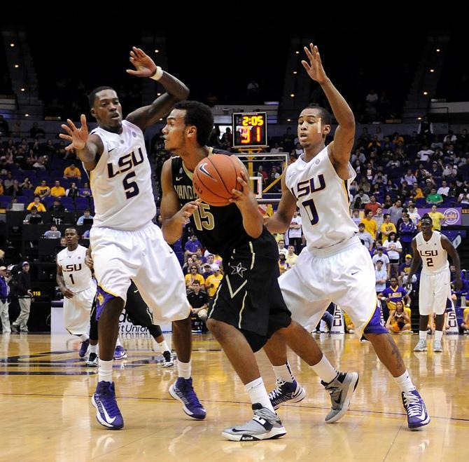 LSU junior forward Shavon Coleman (5) and senior Charles Carmouche (0) guard Wednesday, Feb. 6, 2013 Vanderbilt freshman Kevin Bright (15) during the Tigers' 57-56 win over the Commodores in the PMAC.
 