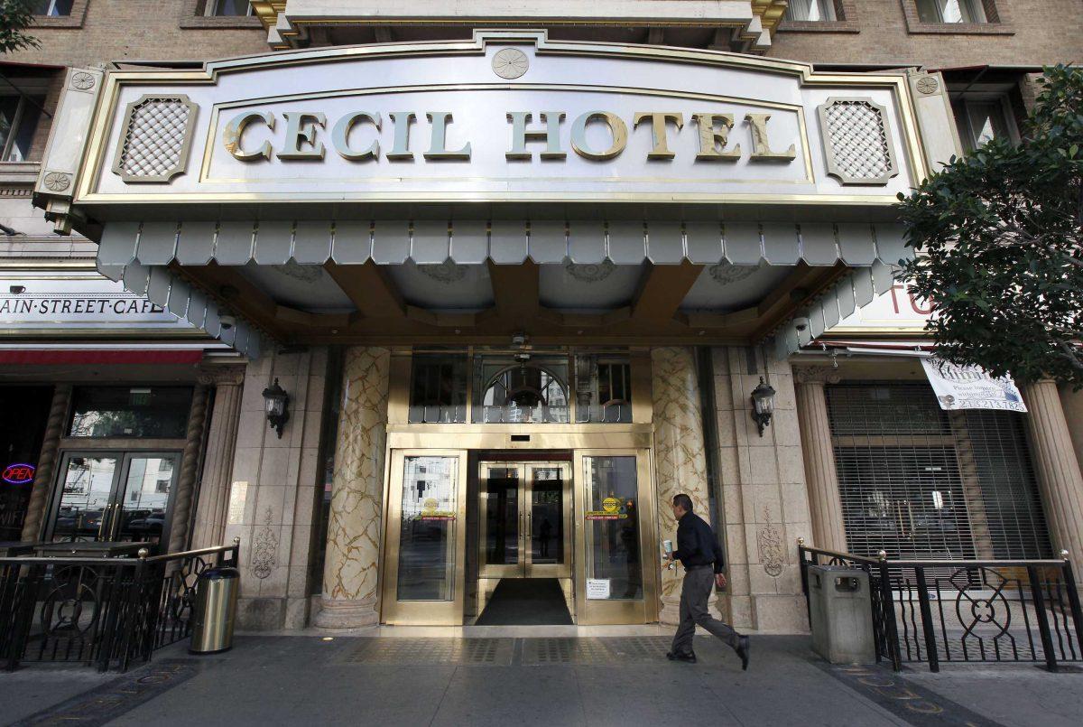 A visitor arrives at the hotel Cecil on Wednesday Feb. 20,2013 where police say the body of a woman was found wedged in one of the water tanks on the roof was that of a missing Canadian guest. Investigators used body markings to identify 21-year-old Elisa Lam, police spokeswoman Officer Diana Figueroa said late Tuesday. A maintenance worker at the Cecil Hotel found the body earlier in the day after guests complained of low water pressure. (AP Photo/Nick Ut)