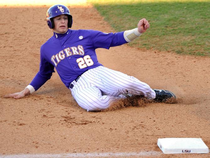 LSU junior catcher Ty Ross (26) slides Saturday, Feb. 16, 2013 into third base during the 5-1 victory in the second game of the opening series against Maryland at Alex Box Stadium.
 